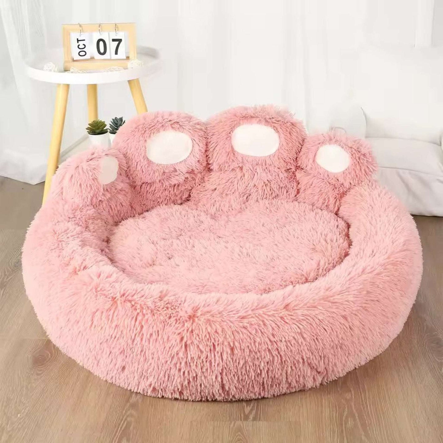 Pink Blufi Bear Paw-shaped dog bed for small pets, soft plush pet accessory with cozy paw design.